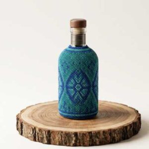 Licorera artesanal de lujo revestida a mano con microchaquira huichola, botella de colección premium.